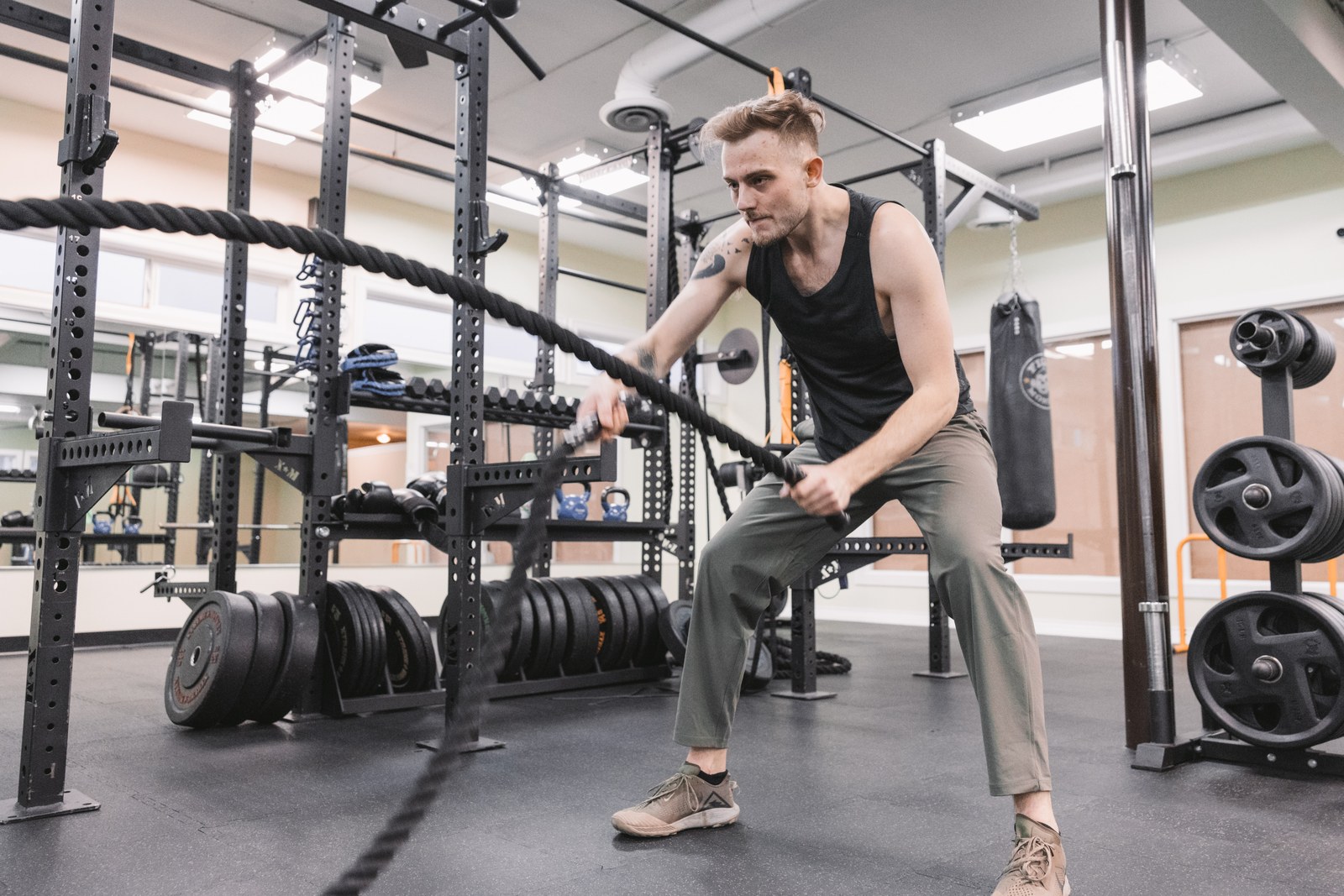 Person training with battle ropes in a gym