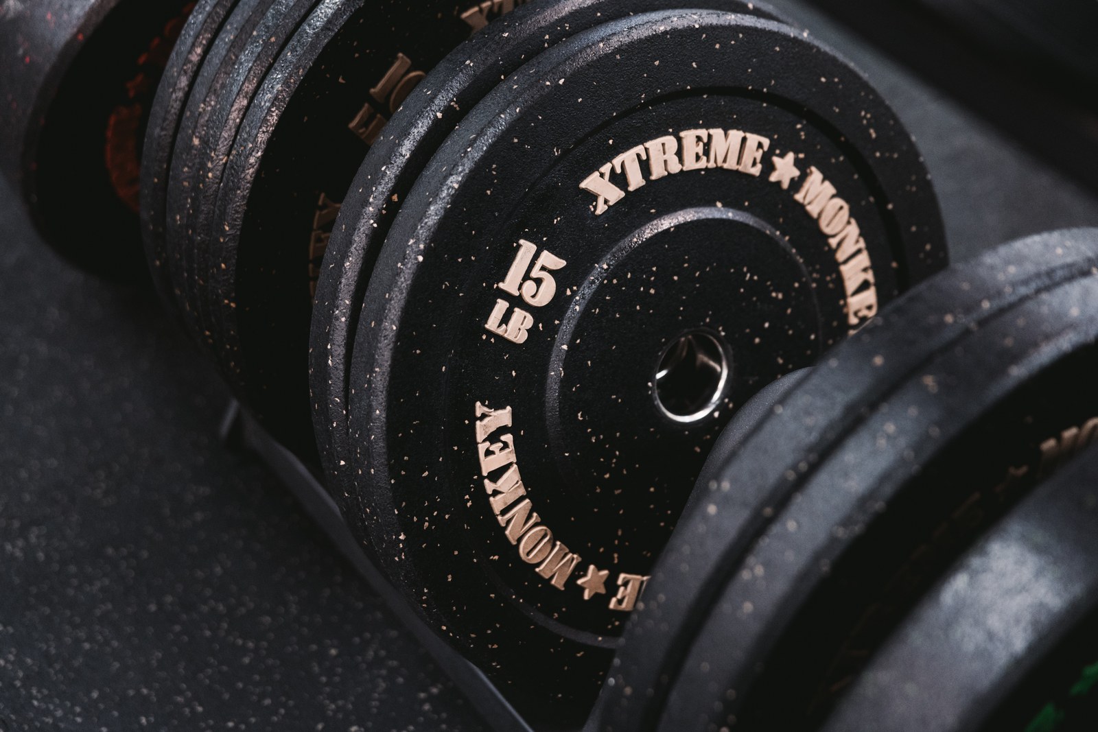 Close view of black weight plates with white fifteen-pound markings